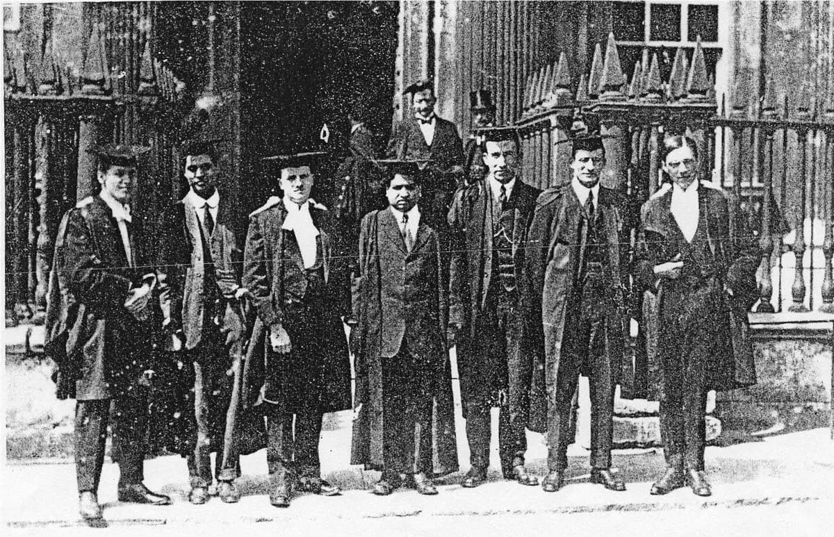 Ramanujan, at the centre of the group, standing with fellow scholars in academic dress outside the Senate House