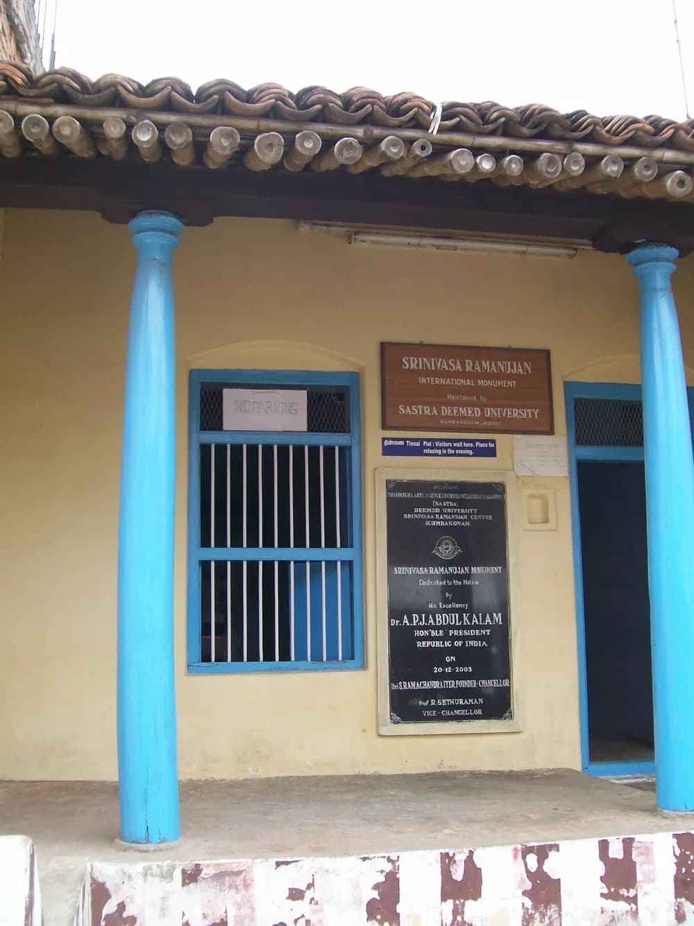 Ramanujan’s home in Kumbakonam: a tiled-roof house with blue pillars and memorial plaques by the door