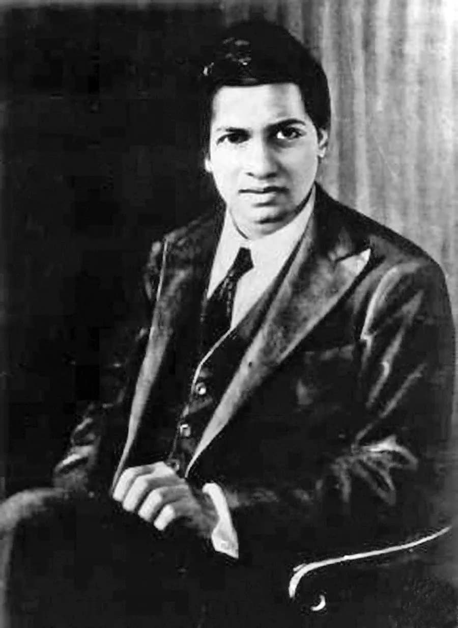 Studio portrait of Srinivasa Ramanujan, seated, in a jacket and tie